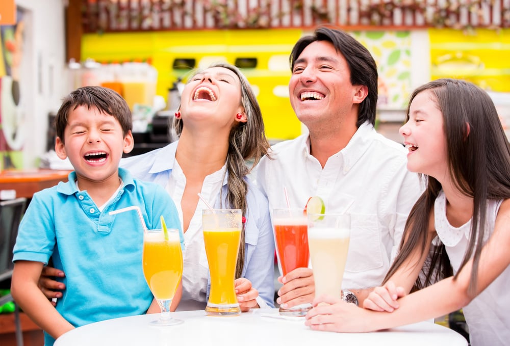 Happy family at the diner enjoying together and laughing