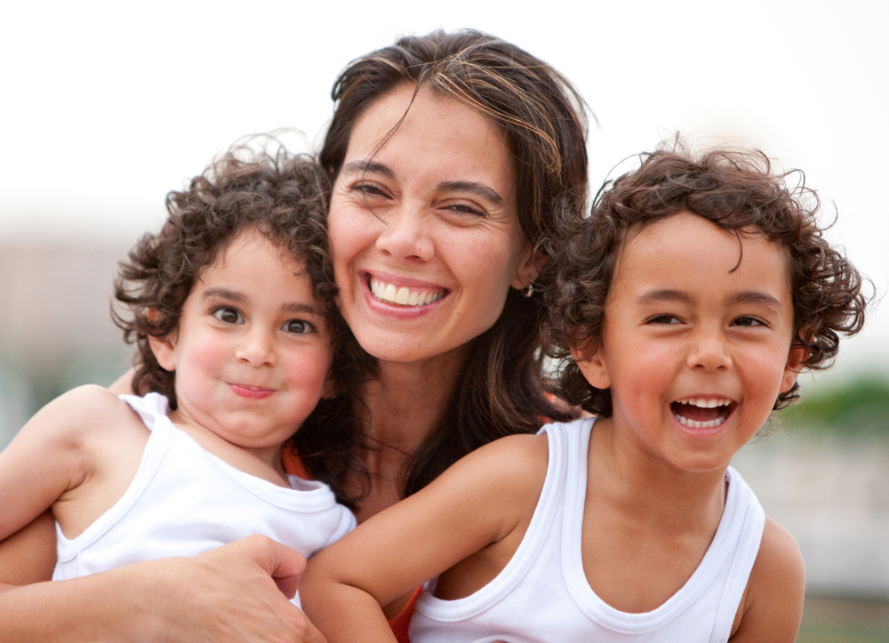 Beautiful portrait of a mother with her two sons outdoors